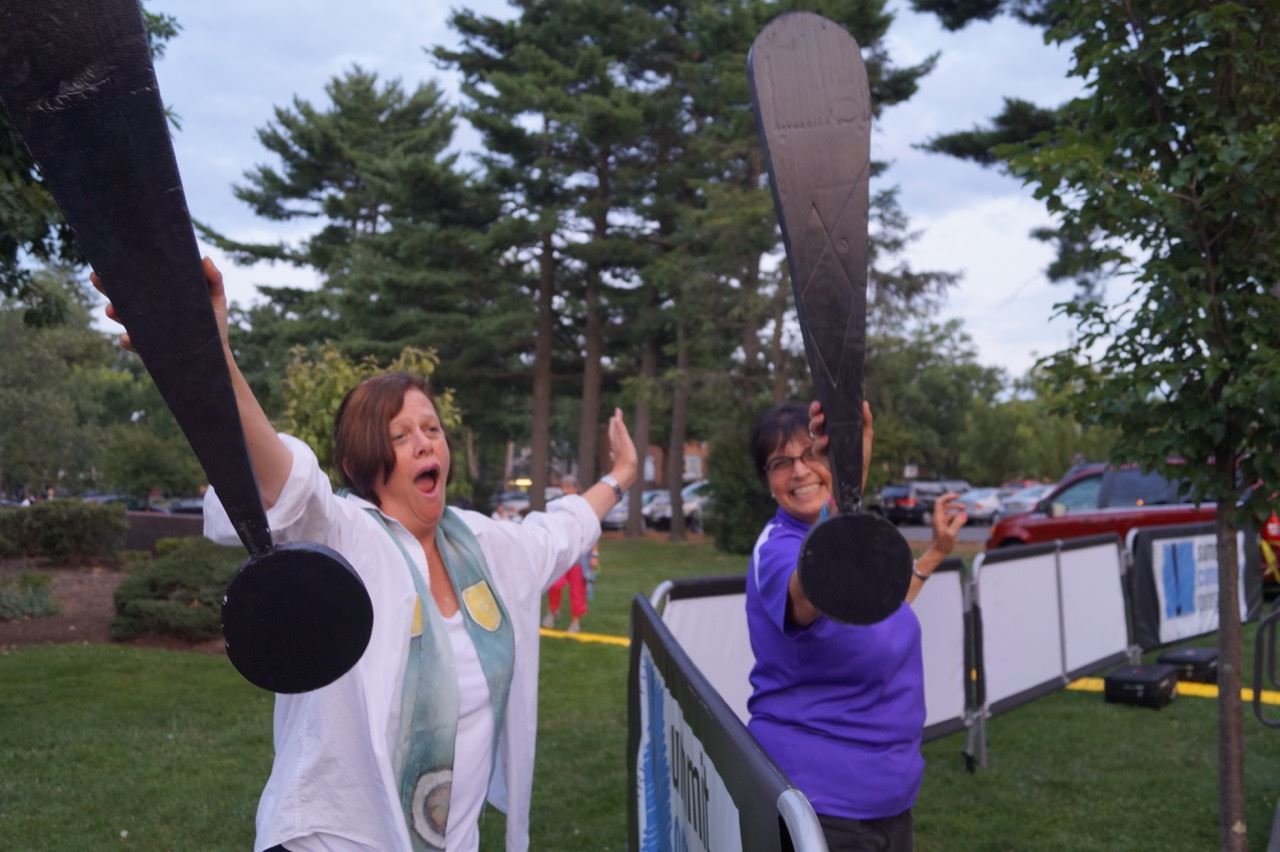 A Share the Fun representative and another woman poses with the exclamation points.